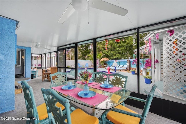 sunroom / solarium featuring ceiling fan