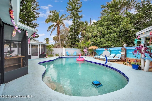 view of pool with a sunroom