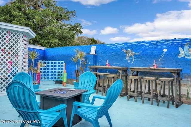 view of patio featuring a bar and a fire pit