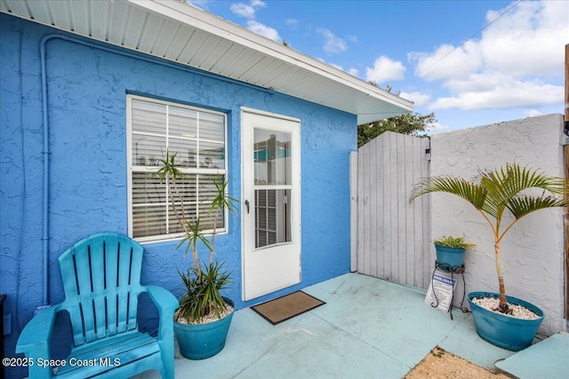 property entrance featuring a patio