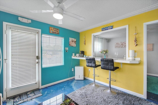 kitchen with ceiling fan and a textured ceiling