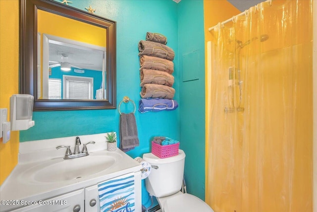 bathroom featuring a shower with curtain, vanity, and toilet