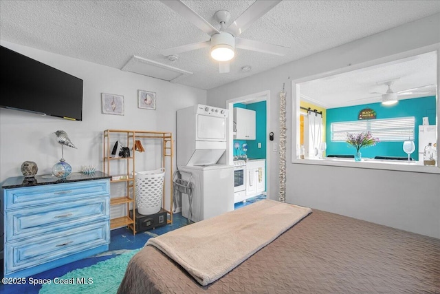 bedroom featuring ceiling fan, stacked washing maching and dryer, fridge, dark colored carpet, and a textured ceiling