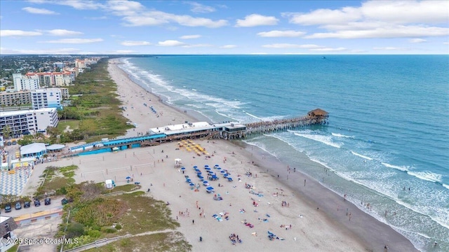 drone / aerial view with a water view and a beach view