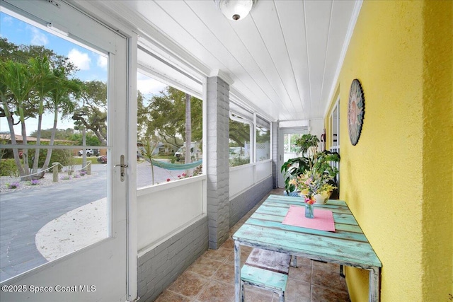 sunroom / solarium featuring wooden ceiling