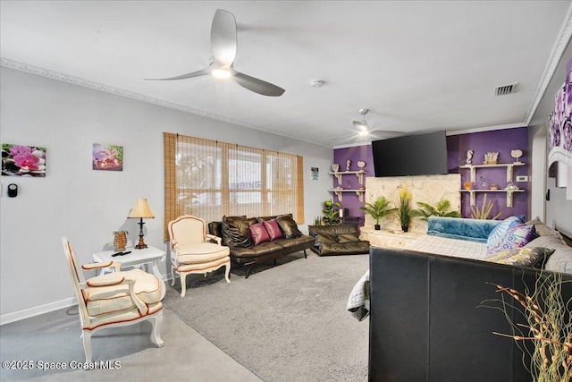 carpeted living room featuring ceiling fan and ornamental molding