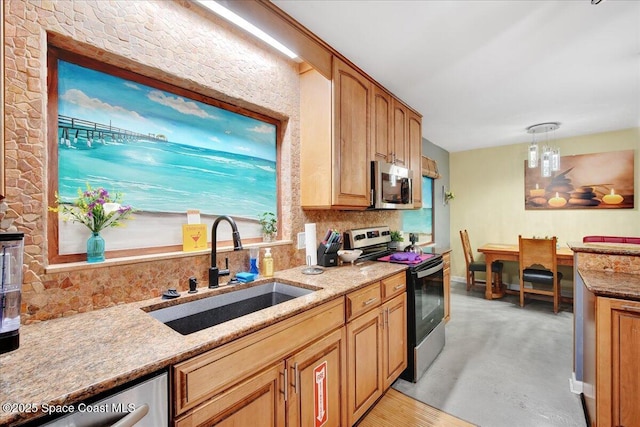 kitchen with appliances with stainless steel finishes, decorative light fixtures, sink, decorative backsplash, and light stone countertops