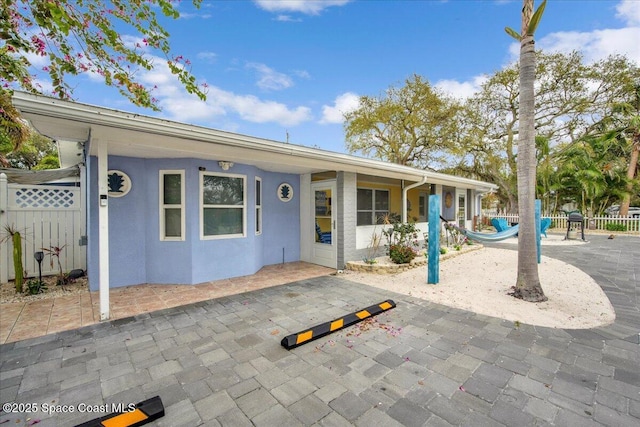 view of front facade with a swimming pool and a patio area