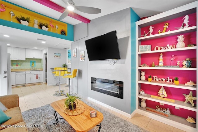 tiled living room featuring ceiling fan and sink