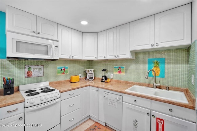 kitchen with sink, white cabinets, decorative backsplash, light tile patterned floors, and white appliances