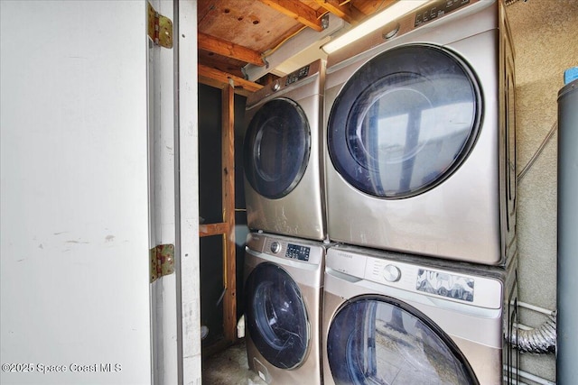 clothes washing area featuring stacked washer and dryer