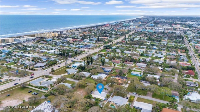 drone / aerial view with a water view and a view of the beach