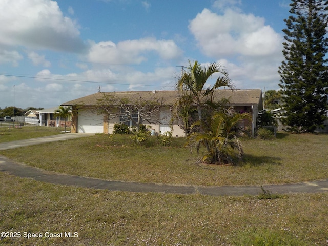 view of front of property featuring a garage and a front lawn