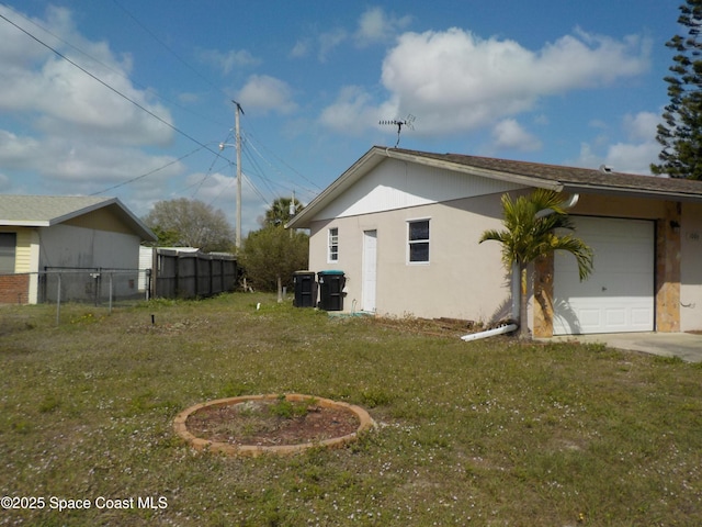 view of property exterior with a garage and a yard