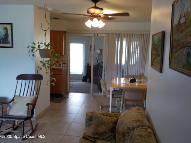 tiled living room featuring ceiling fan