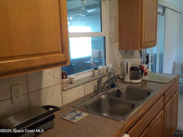 kitchen featuring sink and backsplash