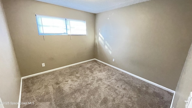 empty room featuring a textured ceiling, baseboards, and carpet flooring