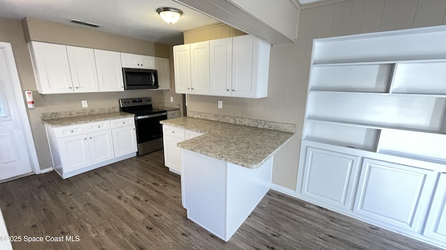 kitchen featuring dark wood-style floors, visible vents, white cabinetry, and stainless steel appliances