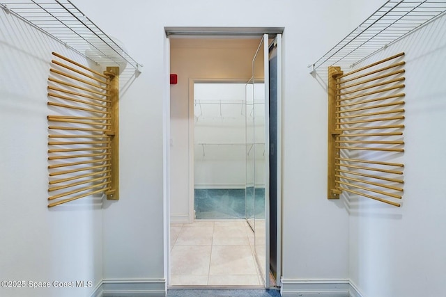 interior space featuring baseboards and tile patterned floors