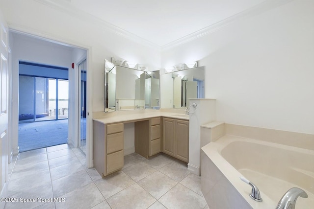 bathroom featuring ornamental molding, tile patterned flooring, a garden tub, and vanity