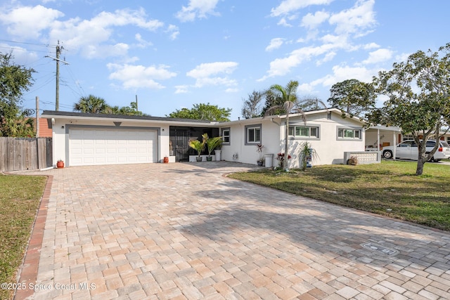 230 Andros Dr, Merritt Island, FL 32952 - ranch-style house with a garage and a front lawn