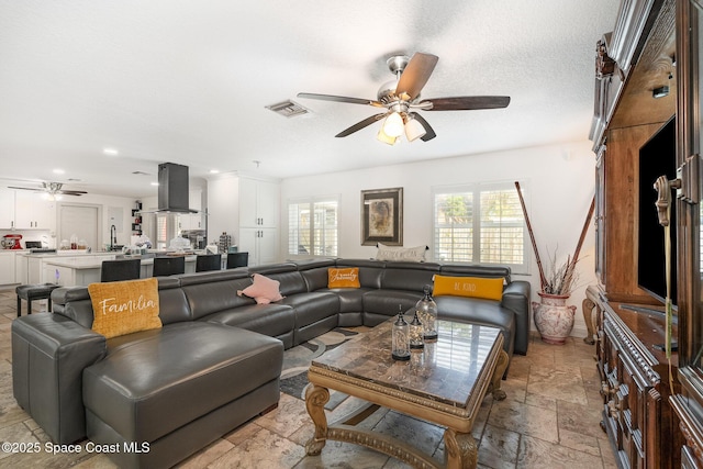 230 Andros Dr, Merritt Island, FL 32952 - living room with a textured ceiling and ceiling fan