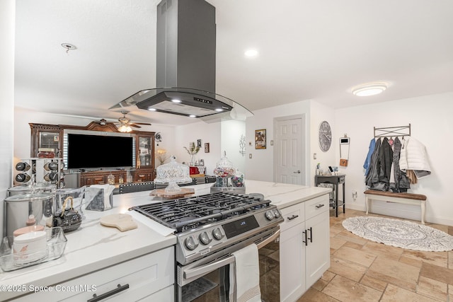 230 Andros Dr, Merritt Island, FL 32952 - kitchen with stainless steel range with gas cooktop, light stone countertops, white cabinets, and island exhaust hood