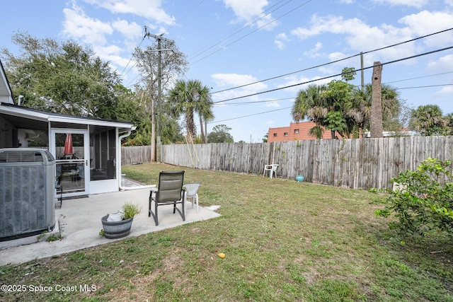 230 Andros Dr, Merritt Island, FL 32952 - view of yard with a sunroom, a patio area, and central air condition unit