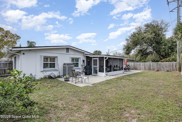 230 Andros Dr, Merritt Island, FL 32952 - back of house featuring a yard, a patio area, and a sunroom