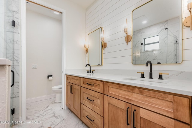 bathroom with toilet, vanity, and a shower with shower door