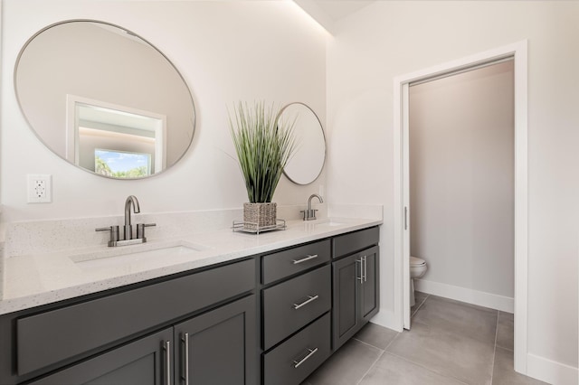 bathroom with vanity, tile patterned floors, and toilet