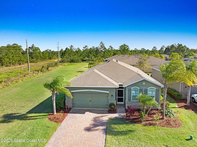 ranch-style home featuring a garage and a front yard