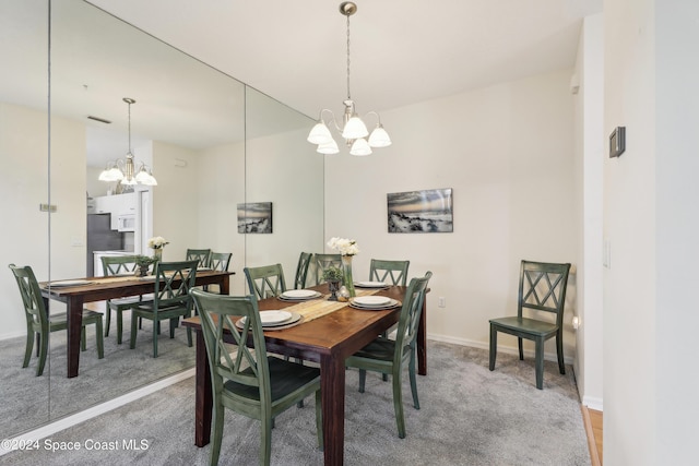 carpeted dining space with a notable chandelier, baseboards, and visible vents