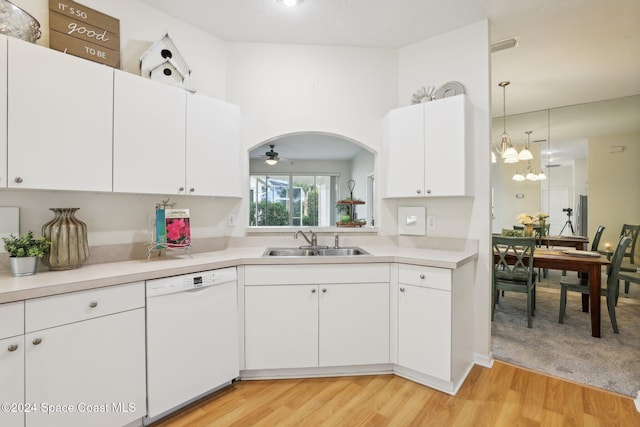 kitchen featuring a sink, hanging light fixtures, light countertops, white cabinetry, and dishwasher