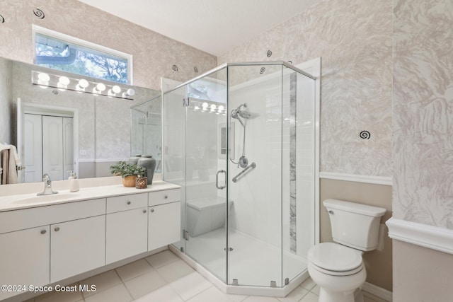 full bathroom featuring vanity, a shower stall, wallpapered walls, toilet, and tile patterned floors