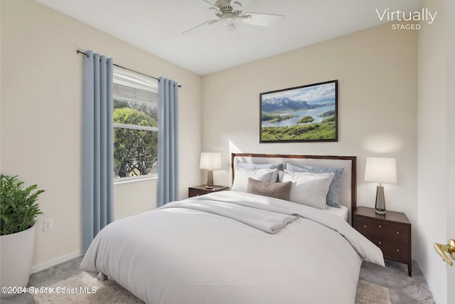 bedroom featuring light carpet and a ceiling fan