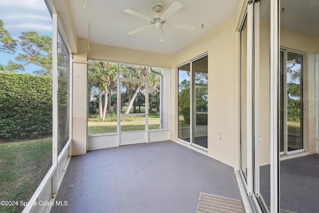 unfurnished sunroom with a ceiling fan