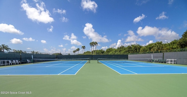 view of sport court featuring fence