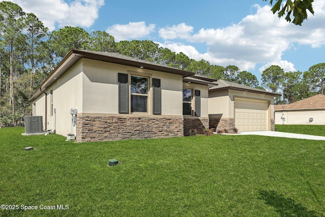 view of front of house featuring a garage, central AC unit, and a front lawn