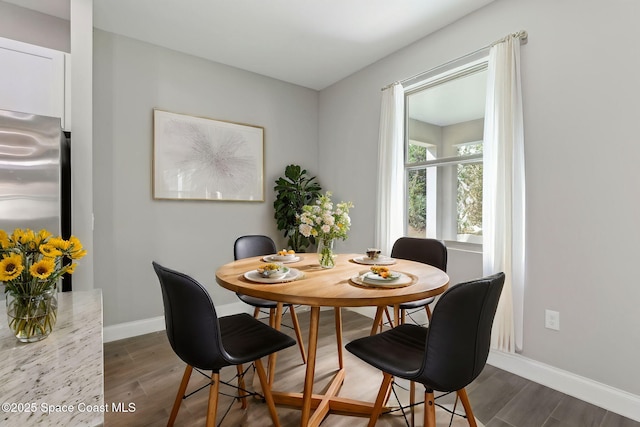 dining space featuring dark hardwood / wood-style flooring