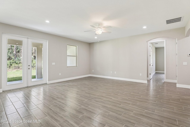 unfurnished room featuring french doors and ceiling fan