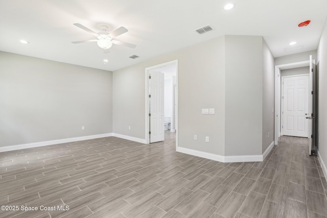 empty room featuring ceiling fan and light hardwood / wood-style flooring