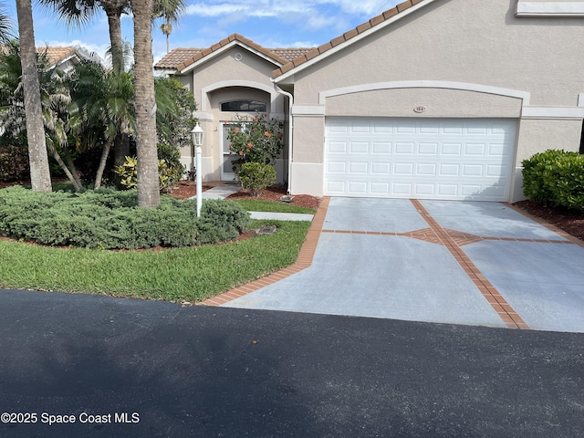 184 Tramore Pl, Melbourne Beach, FL 32951 - mediterranean / spanish-style home featuring an attached garage, stucco siding, concrete driveway, and a tile roof