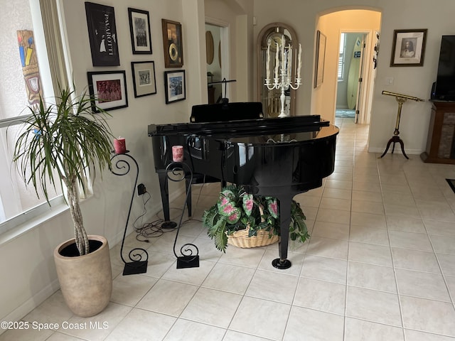 184 Tramore Pl, Melbourne Beach, FL 32951 - sitting room featuring arched walkways, baseboards, and a wealth of natural light
