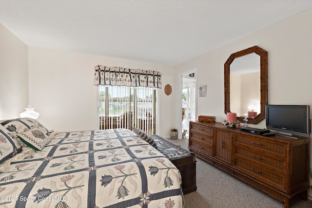 carpeted bedroom featuring a textured ceiling