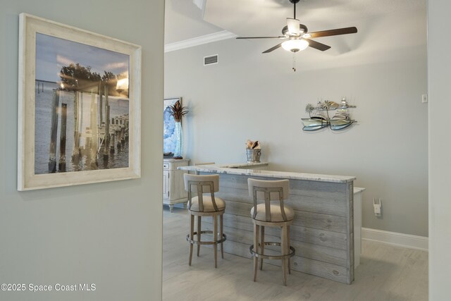 4955 Dixie Hwy NE Unit 801, Palm Bay, FL 32905 - bar featuring visible vents, light wood-style floors, a bar, crown molding, and baseboards