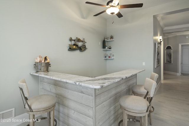 4955 Dixie Hwy NE Unit 801, Palm Bay, FL 32905 - bar featuring visible vents, a bar, crown molding, light wood finished floors, and baseboards