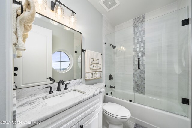 4955 Dixie Hwy NE Unit 801, Palm Bay, FL 32905 - full bathroom featuring combined bath / shower with glass door, visible vents, toilet, and vanity