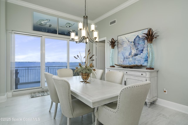 4955 Dixie Hwy NE Unit 801, Palm Bay, FL 32905 - dining area with visible vents, baseboards, an inviting chandelier, and crown molding