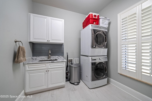 4955 Dixie Hwy NE Unit 801, Palm Bay, FL 32905 - washroom with visible vents, a sink, stacked washing maching and dryer, cabinet space, and baseboards
